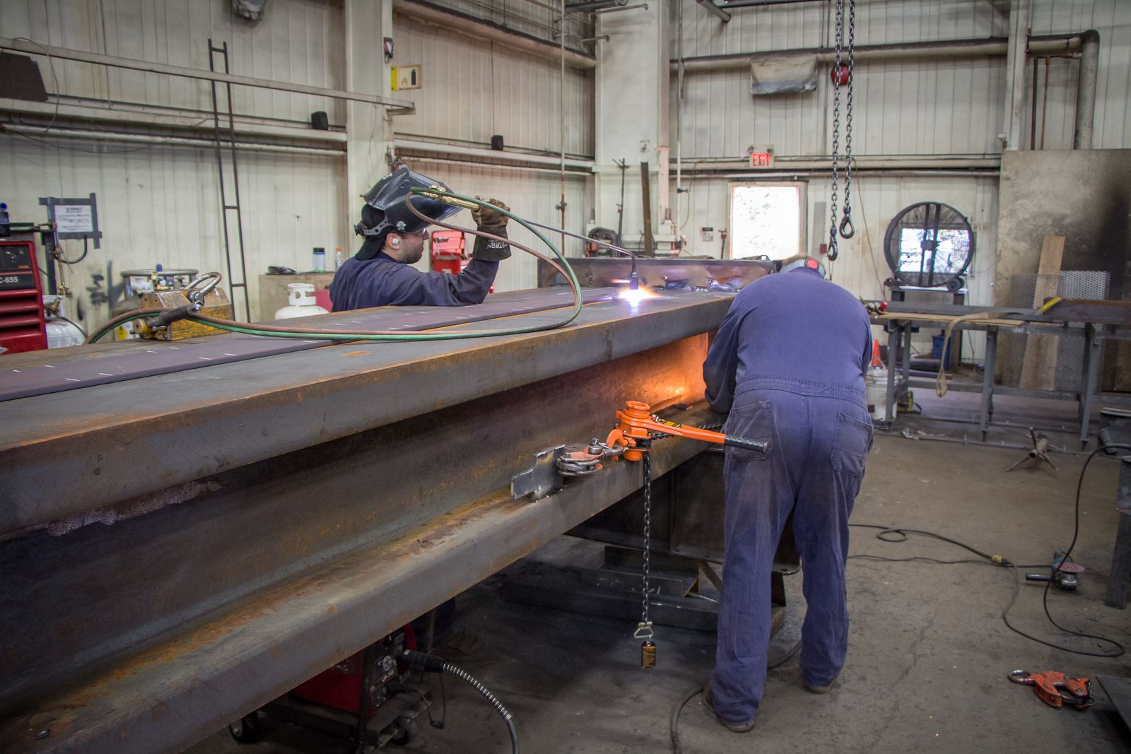 Impact Ironworks welder at work in full PPE