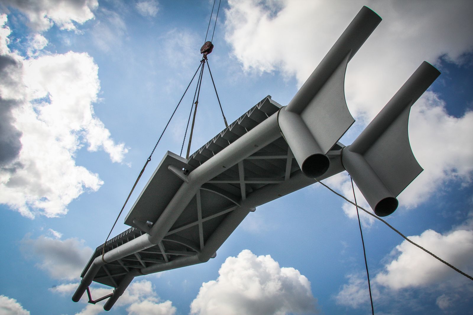 Steel truss lifted into place by crane